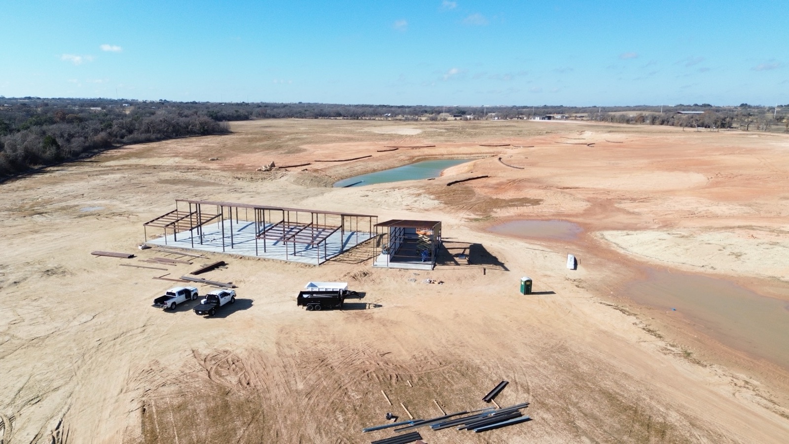Commercial metal building under construction in North Texas, aerial site view